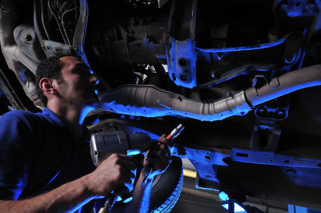 bigstock Auto mechanic working under dr 19473515